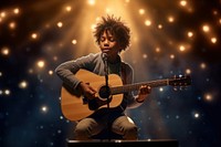 A 7 years old black boy playing acoustic guitar spot light lighting talent show scene microphone. 