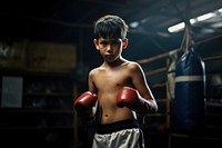 A 7 years old thai boy practicng muay thai a boy wearing muaythai uniform boxing punching. 