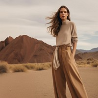 A woman standing wearing a minimal colorful outfit nature outdoors desert. 