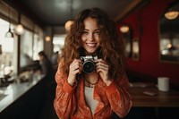 Enjoy woman holding camera portrait adult photo. AI generated Image by rawpixel.