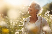 Senior woman hiking through flower field adult contemplation tranquility. 