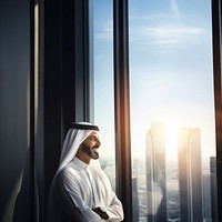 Photo of an Arabic businessman looking out of a window. 