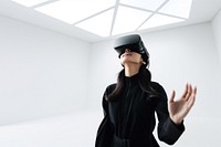 South-East asian girl playing VR game wearing all black outfit. 