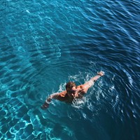 Swimmer swimming recreation outdoors nature. AI generated Image by rawpixel.