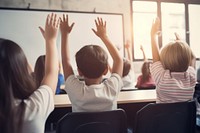 Elementary student classroom teacher sitting. 