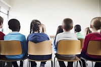 Elementary student school kids classroom sitting adult. 