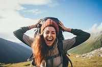 Happy Woman backpacker laughing mountain outdoors. 