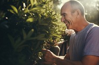 Happy mature man gardening portrait outdoors. 