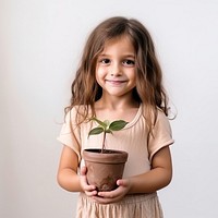 Little girl hand holding potted give portrait child plant. 