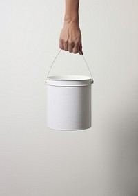 Hand carrying a paint bucket lighting standing holding. 