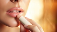 Woman holding lip balm cosmetics lipstick perfection. 