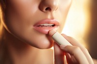 Woman holding lip balm cosmetics lipstick applying. 