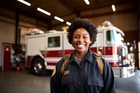 Firefighter standing vehicle smiling.  