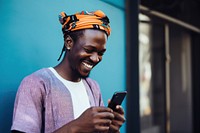 African man smiling looking mobile phone. 