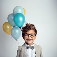 Little boy wearing glasses having a party birthday portrait balloon smile. 