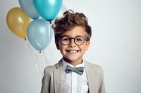 Little boy wearing glasses having a party birthday portrait balloon smile. AI generated Image by rawpixel.