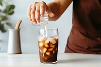 Hand pouring milk coffee drink soda. 