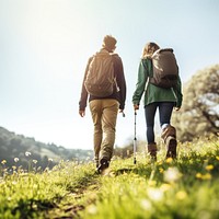 photo of hiking couple set off across hillside meadow. 