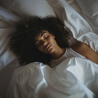 photos of a black woman lying on the side sleeping in white bed. AI generated Image by rawpixel.