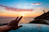 Malibu sunset hand outdoors horizon. AI generated Image by rawpixel.