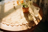 A wooden table tablecloth furniture centrepiece. AI generated Image by rawpixel.