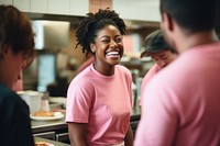 A black woman fast food employee laughing adult togetherness. 