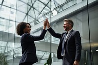 Professionals giving high five standing office adult. 