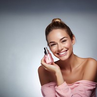 Smiling woman cosmetics perfume bottle. 