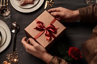 Hands exchanging gift box birthday table paper. AI generated Image by rawpixel.