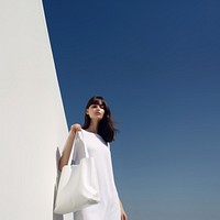 Hold white tote bag outdoors adult architecture. 