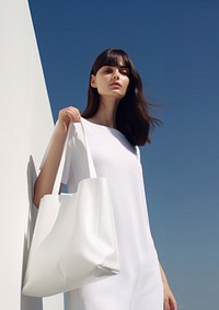 Hold white tote bag handbag adult hairstyle. 