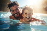 Little boy swimming laughing father. 