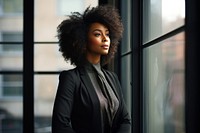 Businesswoman standing portrait window. 