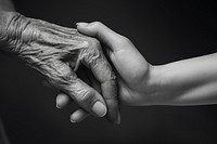 Women holding old woman hand finger black monochrome. 