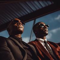 photo of african American men look up the same way, wear suit and sunglasses.  