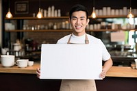 Asian male barista holding a white sign smiling waiter adult. 