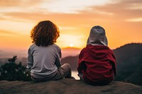 Two diversity kids watching sunset outdoors nature adult. 