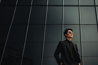 Photo of asian men look up the same way, wear suit and sunglasses.  