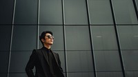 Photo of asian men look up the same way, wear suit and sunglasses.  