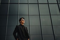 Photo of asian men look up the same way, wear suit and sunglasses.  