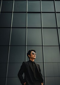 Photo of asian men look up the same way, wear suit and sunglasses. AI generated Image by rawpixel. 