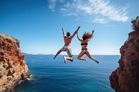 Jumping a cliff diving outdoors nature. 