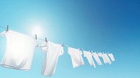 Eco friendly laundry drying on shirt line against a blue sky blackground.  