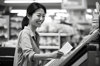 Smiling asian woman supermarket portrait paying. 