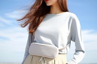 All white waist bag handbag sweater sleeve. 