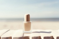 Nail polish bottle cosmetics beach day. 