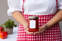 Strawberry jam ketchup holding food. 