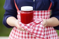 Strawberry jam ketchup holding food. 