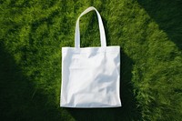 Tote bag handbag grass white. AI generated Image by rawpixel.