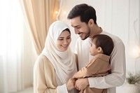 Happy Muslim family reading quran together smiling father child. 